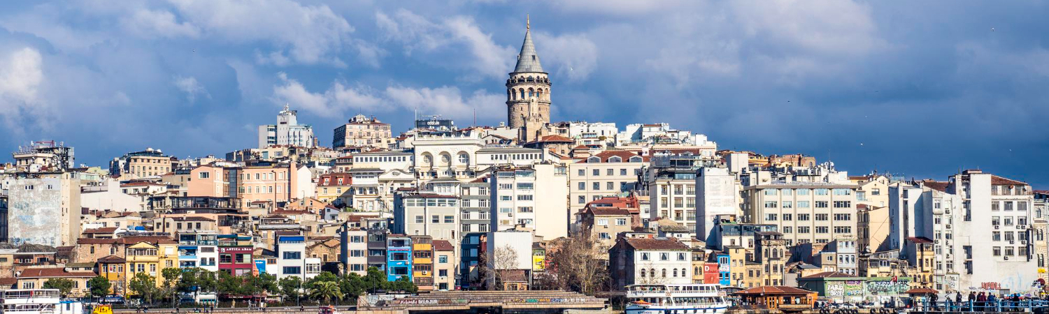 Buildings in city against cloudy sky in Istanbul